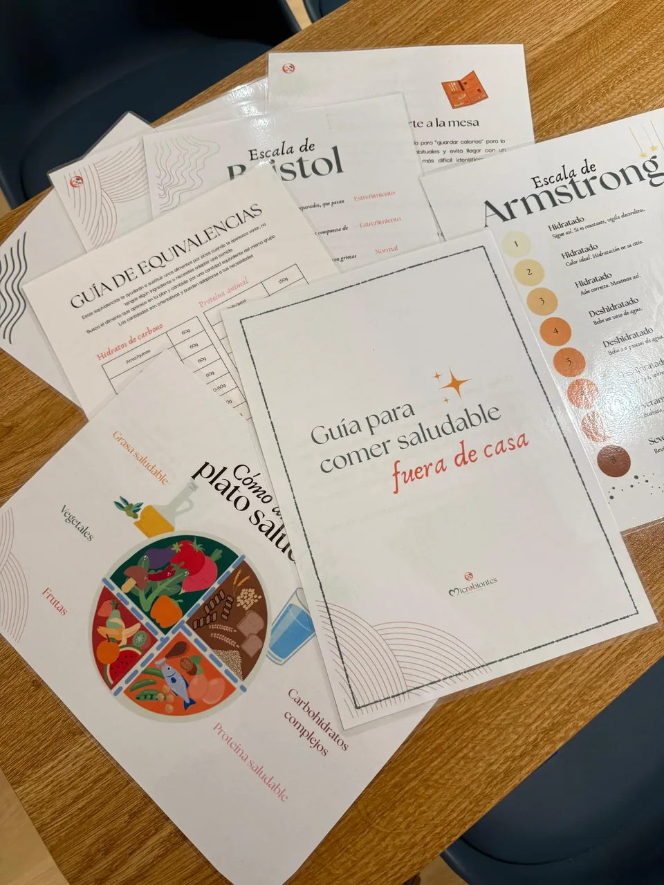 Laminated Microbiontes patient guides on the desk